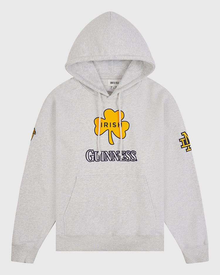 Express your Irish pride with the Notre Dame X Guinness Heavyweight Pullover Hoodie by Ebbets Field. Featuring a light gray design, this hoodie displays a bold yellow shamrock and “IRISH” above the iconic GUINNESS logo on the front. Yellow and navy logos accent the sleeves, while a front pocket and cozy hood add comfort and functionality—making this Irish heritage hoodie perfect for both style and comfort.