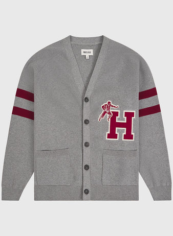 The Ebbets Field Harvard University Cotton Varsity Cardigan features a gray design with two front pockets, black buttons, maroon double stripes on the sleeves, and a large maroon “H” patch adorned with a football player graphic on the left chest.