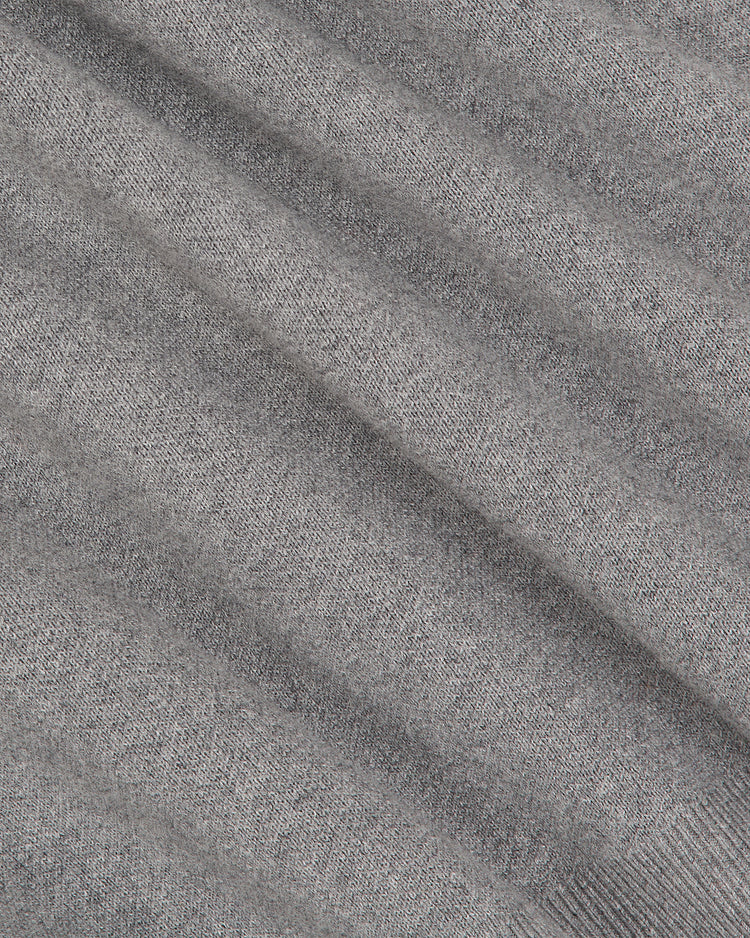 Close-up of the Ebbets Field Harvard University Cotton Varsity Cardigan in gray, featuring a soft ribbed knit texture displayed in diagonal lines across the image. The evenly lit material highlights the cardigan’s weave and distinctive pattern.