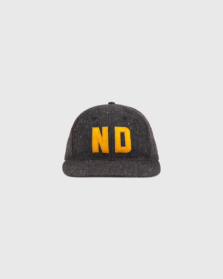 A Notre Dame X Magee Irish Donegal Wool Ballcap by Ebbets Field in dark gray, featuring yellow embroidered ND lettering on the front, displayed against a plain light background.