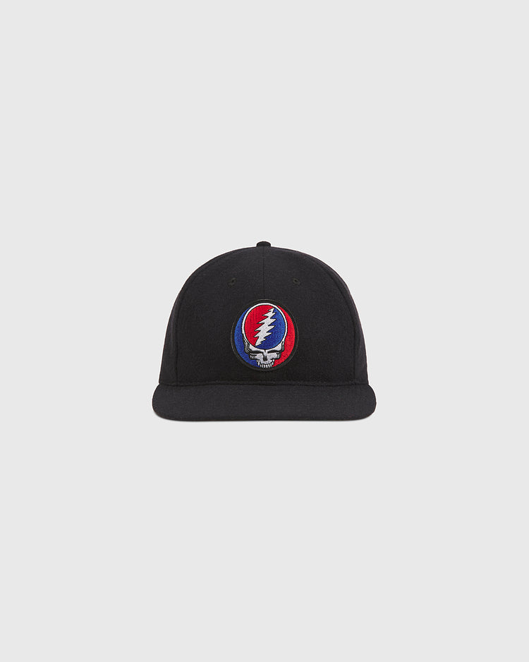 The Ebbets Field Grateful Dead Stealie Wool Ballcap is a black wool hat featuring a vibrant embroidered Stealie logo—a skull adorned with a red and blue lightning bolt—on the front. Shown against a simple light gray background, it’s an ideal accessory for any Grateful Dead fan.