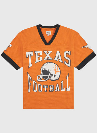 The Ebbets Field University of Texas Mesh Football Jersey features bold black trim, a white football helmet graphic, and “TEXAS FOOTBALL” in prominent lettering across the front. A classic white longhorn adorns the sleeve, capturing timeless University of Texas style inspired by vintage Longhorn jerseys.