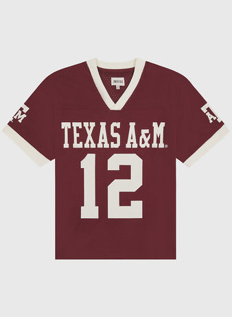 Crafted by Ebbets Field, the Texas A&M Mesh Football Jersey showcases a vintage maroon mesh design with sharp white trim, featuring “TEXAS A&M” and the number 12 prominently on the front, while “A&M” appears on the left sleeve for timeless game day style.