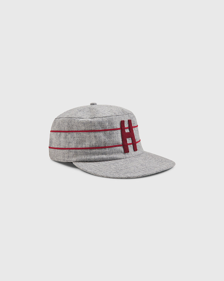 The Ebbets Field Harvard University 1899 Pillbox Wool Ballcap is shown at an angle on a plain white background, featuring a gray design with two horizontal maroon stripes and a prominent maroon “H” on the front.