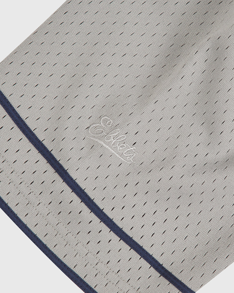 Close-up of light grey mesh fabric with small perforations, a dark blue border, and embroidered white script text reading “Los Angeles” on the Ebbets Field Los Angeles (PCL) 1942 Mesh Button Up Road Jersey.