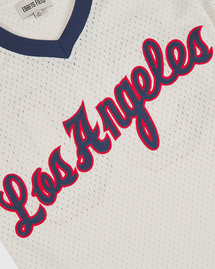 An Ebbets Field LA Angels (PCL) 1957 V-Neck Mesh Road Jersey in white mesh with dark blue trim and “Los Angeles” in red script outlined in blue across the front.