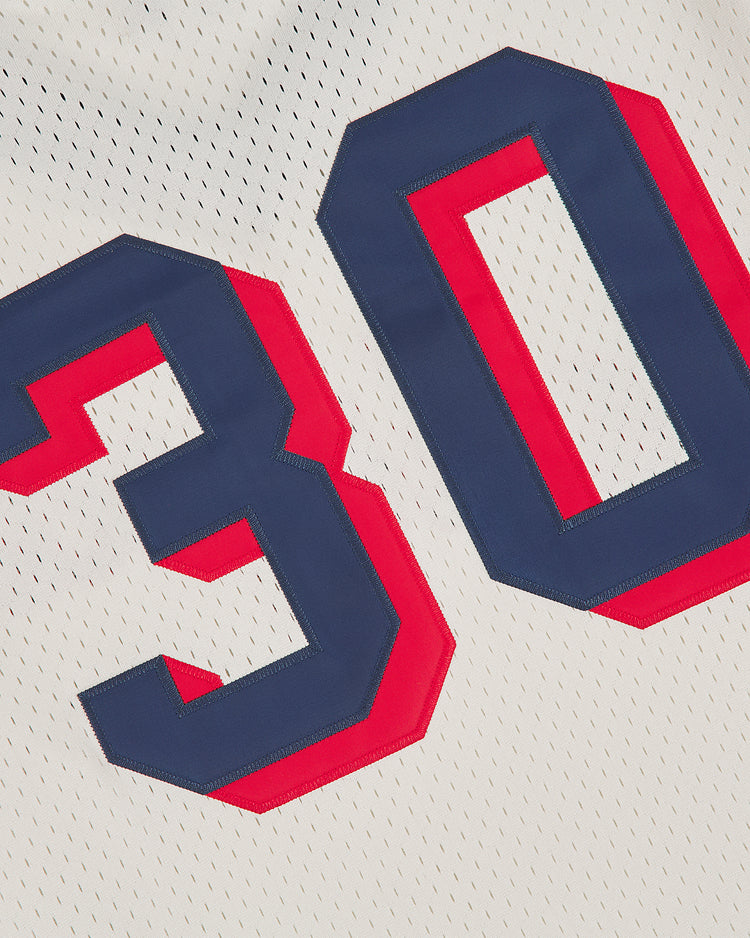Close-up of the Los Angeles Angels (PCL) 1957 Mesh V-Neck Home Jersey by Ebbets Field, featuring large blue and red outlined number 30 stitched on the white fabric.