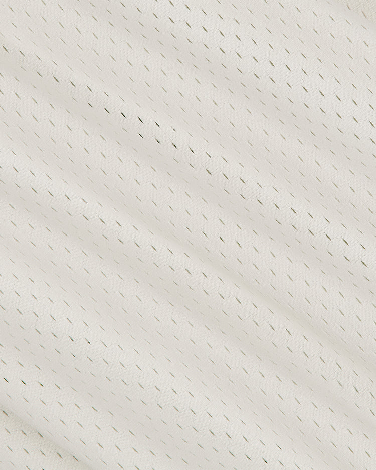 Close-up of the Ebbets Field Los Angeles Angels (PCL) 1957 Mesh V-Neck Home Jersey, highlighting its white mesh fabric with small, evenly spaced holes arranged in a diagonal pattern and showing subtle folds and texture.