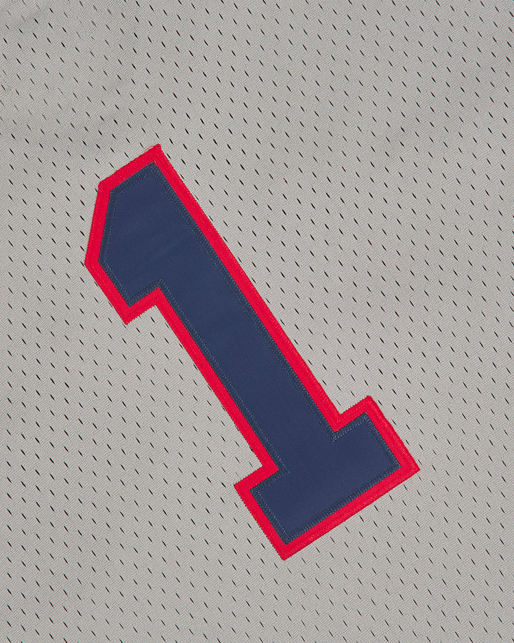 A blue number one with a red outline is sewn onto the gray mesh fabric of the Oakland Oaks 1948 V-Neck Mesh Road Jersey by Ebbets Field.