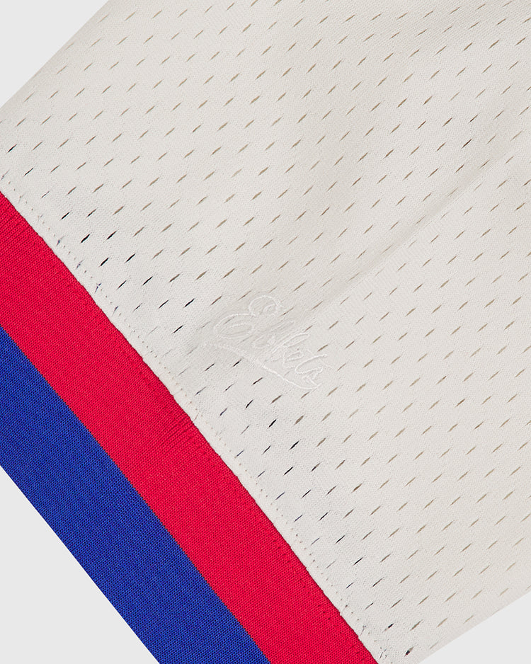 A close-up of the Ebbets Field Hollywood Stars 1940 Mesh V-Neck Home Jersey, showcasing its white mesh fabric with small perforations, accented by red and blue stripes along the edge and subtle SikSilk embroidery.