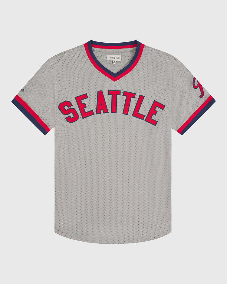 The Ebbets Field Seattle Rainiers 1951 Mesh V-Neck Road Jersey features SEATTLE in bold red and blue lettering across the chest, gray mesh fabric, navy and red trim on the sleeves and collar, and a small label at the neck.