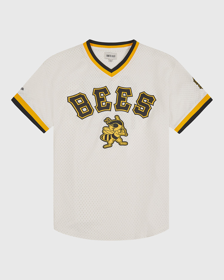 The Ebbets Field Salt Lake City Bees 1959 Mesh V-Neck Home Jersey features a white mesh design with black and yellow trim, bold “BEES” lettering across the chest, and a central cartoon bee character sporting a cap and gloves, perfectly capturing the playful spirit and classic style of 1959 baseball jerseys.