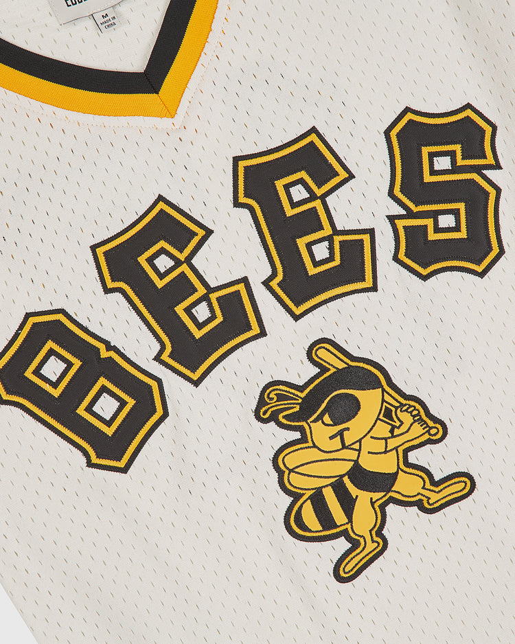 Closeup of the Ebbets Field Salt Lake City Bees 1959 Mesh V-Neck Home Jersey, showcasing white mesh fabric with bold yellow and black “BEES” lettering and a cartoon bee holding a bat underneath—faithfully inspired by the classic 1959 Salt Lake City Bees baseball jersey.