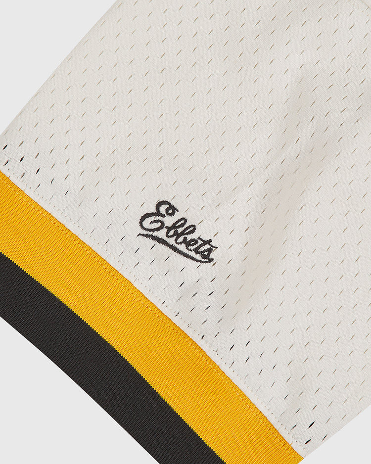 A close-up of the Salt Lake City Bees 1959 Mesh V-Neck Home Jersey by Ebbets Field, featuring white mesh throwback fabric, “Ebbets” embroidered in black script, and a yellow-and-black striped ribbed edge at the bottom—evoking the look of a classic Bees jersey.