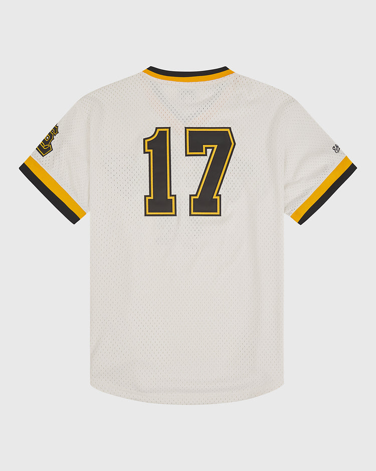 The Ebbets Field Salt Lake City Bees 1959 Mesh V-Neck Home Jersey features a crisp white design with black and gold trim on the collar and sleeves. Large black and gold number 17 is printed on the back, while a yellow, brown, and black patch on the left sleeve pays tribute to the iconic style of the original Salt Lake City Bees jersey from 1959.