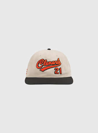 The Clemente Museum X Ebbets Field Cotton Twill Ballcap by Ebbets Field is crafted from beige cotton twill with a black brim, showcasing custom orange Clemente script and the number 21 on the front as a fitting tribute inspired by the Roberto Clemente Museum.