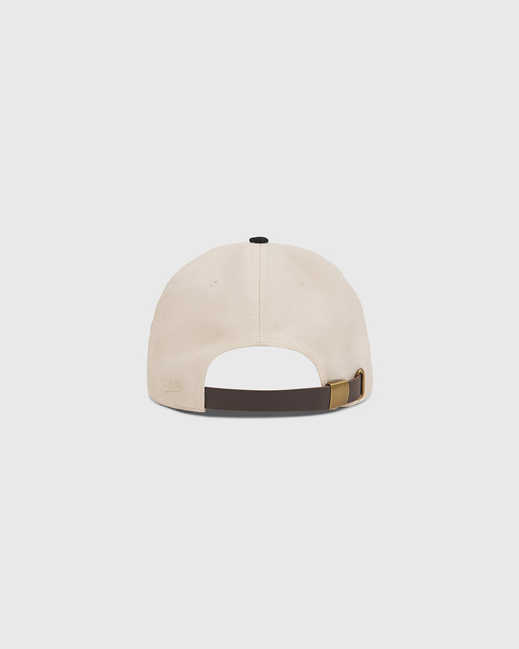 A rear view of The Clemente Museum X Ebbets Field Cotton Twill Ballcap by Ebbets Field, shown in beige cotton twill with a brown adjustable strap, brass buckle, and custom Clemente script, set against a plain white background.