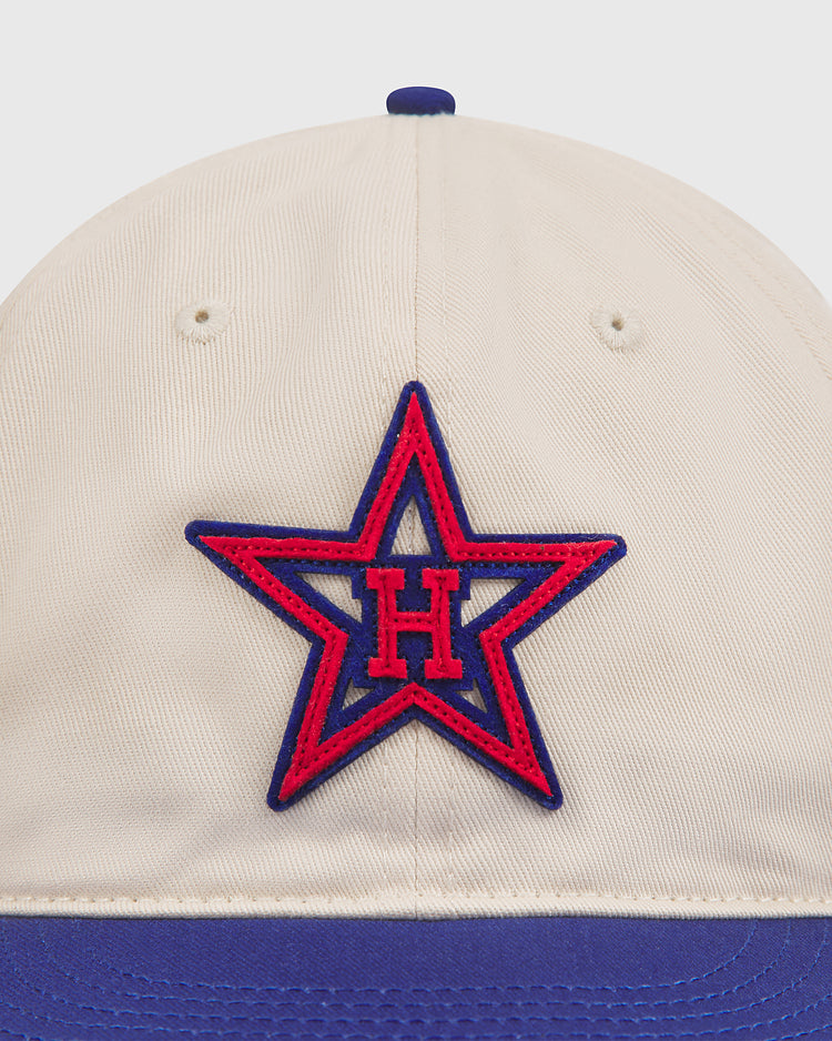 The Ebbets Field Hollywood Stars 1957 Cotton Twill Ballcap features a beige and blue design inspired by the iconic 1957 team, with a red and blue star emblem and a bold embroidered H—an ideal tribute for Gilmore Field enthusiasts.