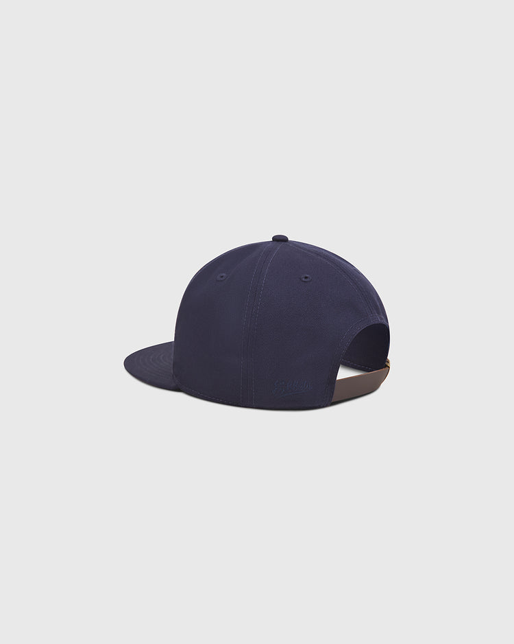 An Ebbets Field Seattle Rainiers 1941 Cotton Twill Ballcap in navy blue is displayed from the back, highlighting its adjustable strap and curved brim. The hat, inspired by the 1941 Pacific Coast League and crafted from durable cotton twill, is set against a plain light gray background.
