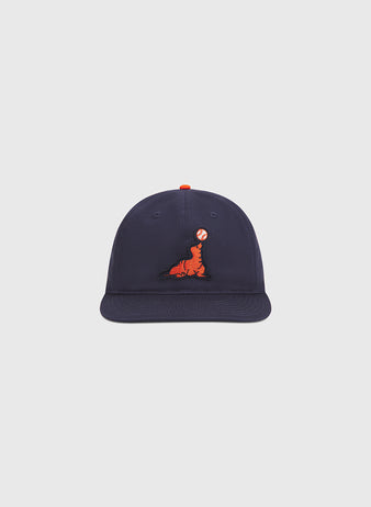 The Ebbets Field San Francisco Seals Cotton Twill Ballcap is a navy blue vintage-inspired baseball hat, featuring an embroidered orange seal balancing a red and white ball on its nose, presented against a plain light background.