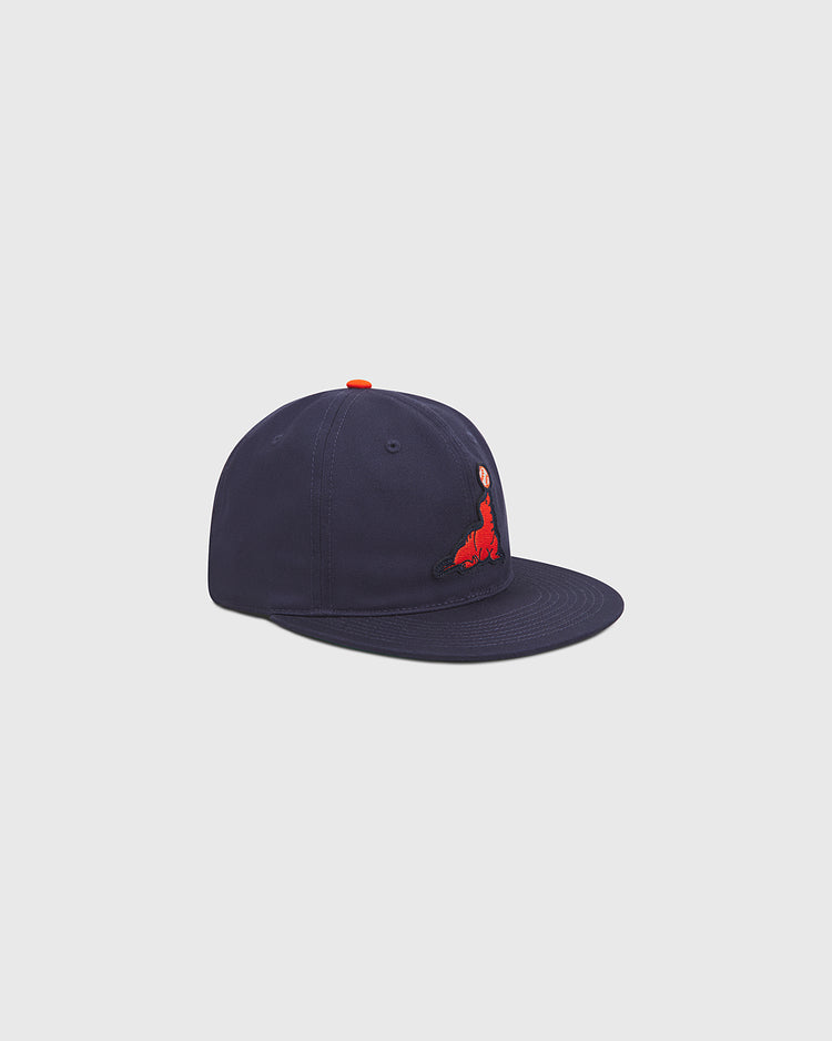 The Ebbets Field San Francisco Seals Cotton Twill Ballcap is a navy-blue baseball cap featuring a red embroidered graphic on the front left panel, shown against a plain light gray background.