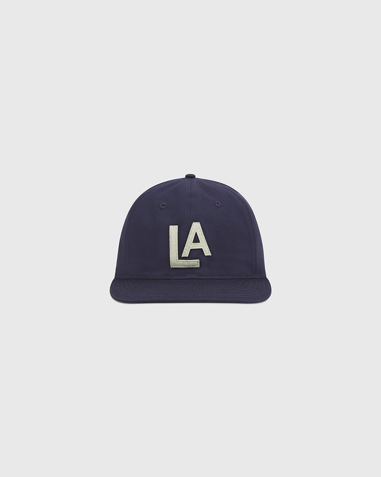 The Ebbets Field Los Angeles Angels (PCL) 1942 Cotton Twill Ballcap features a flat brim and bold white “LA” embroidery on the front, centered against a plain light gray background—an authentic recreation of the classic 1942 minor league baseball hat.