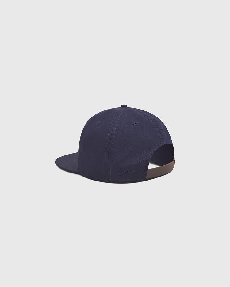 The Ebbets Field Los Angeles Angels (PCL) 1942 Cotton Twill Ballcap is displayed from the back, showcasing its navy blue color, curved brim, top button, ventilation eyelets, and an adjustable brown strap with a metal clasp. Inspired by vintage PCL baseball hats such as the 1942 Los Angeles Angels, this cotton twill cap stands out against a plain light gray background.