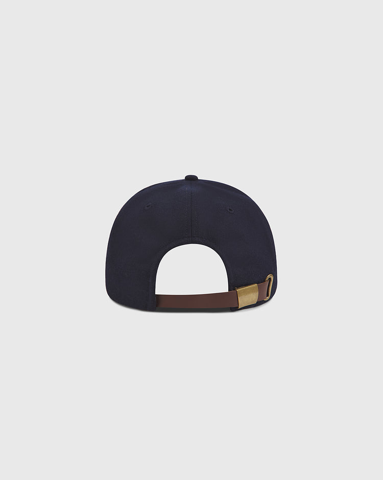 The Ebbets Field San Francisco Seals 1957 Authentic Wool Ballcap is displayed from the back, highlighting its brown adjustable strap with a gold buckle against a plain light gray background. Drawing on the timeless design of vintage baseball hats, this navy blue cap pays tribute to the iconic spirit of the 1957 San Francisco Seals.