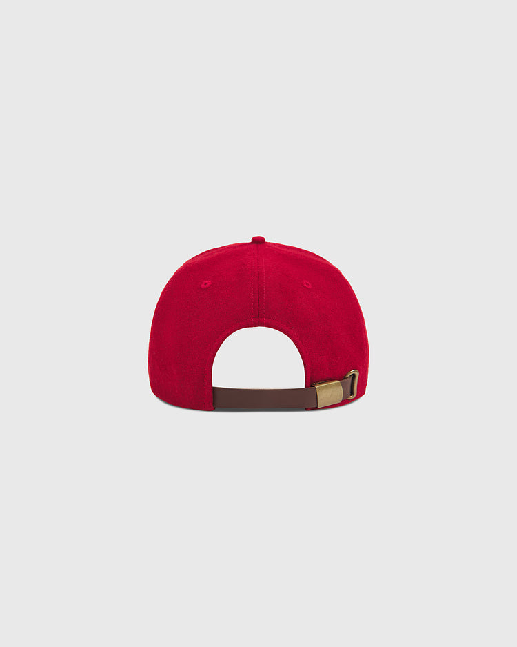 A Seattle City Series Wool Ballcap by Ebbets Field is displayed from the back, showcasing its brown adjustable strap with a metal buckle, set against a plain light gray background. Made from genuine wool broadcloth, this red hat combines classic style and comfort.