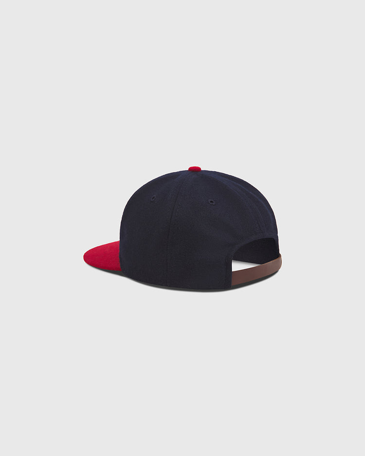 The Ebbets Field Oakland Oaks 1948 Authentic Wool Ballcap features a navy blue wool crown, a red brim and button, and is displayed from the back to show its adjustable strap with no visible logo, echoing the classic vintage style of baseball hats worn by the 1948 Oakland Oaks.