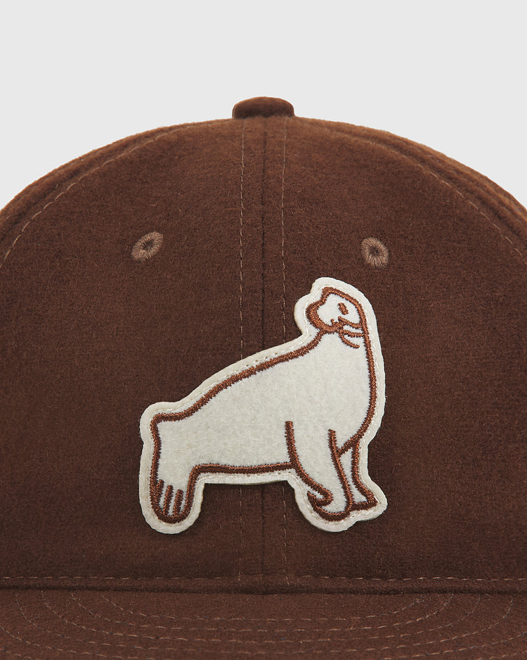 Close-up of the Ebbets Field San Francisco Seals 1940 Wool Ballcap—a brown felt cap with a white and brown embroidered seal patch on the front, designed in the style of a vintage 1940 San Francisco Seals baseball hat.