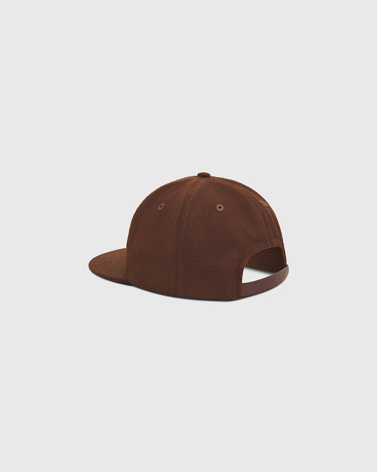 The Ebbets Field San Francisco Seals 1940 Wool Ballcap is pictured from the back at an angle, highlighting its curved brim and adjustable opening. This brown vintage-style cap echoes the classic design of a 1940 San Francisco Seals hat, set against a plain, light gray background.