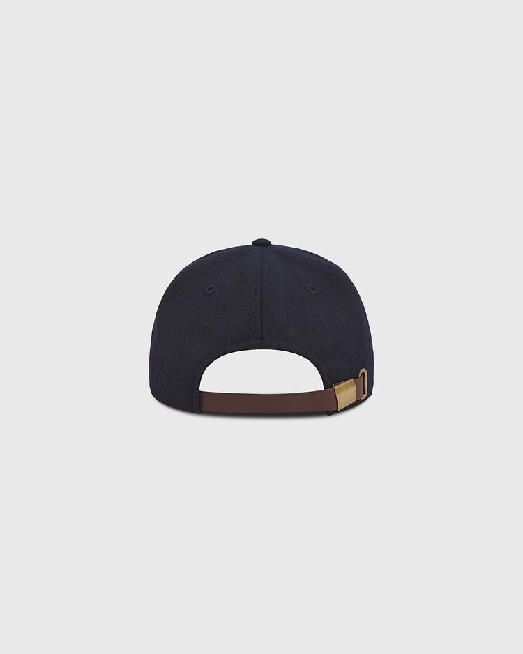 An Ebbets Field Los Angeles Angels (PCL) 1946 Authentic Wool Ballcap, crafted in navy blue wool and inspired by the classic Pacific Coast League team, is shown from the back against a plain light gray background. The image highlights its adjustable brown strap with a brass buckle.