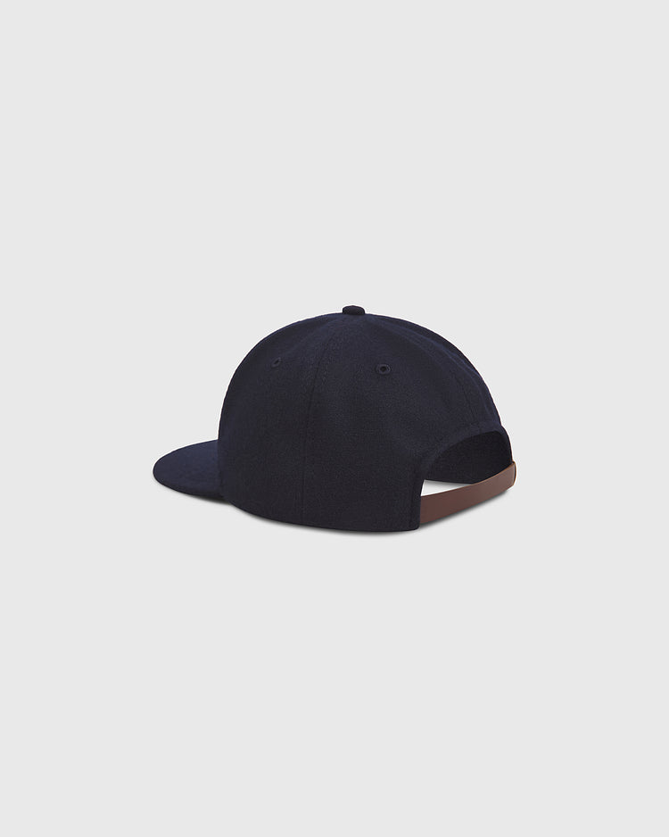 The Los Angeles Angels (PCL) 1946 Authentic Wool Ballcap by Ebbets Field is displayed from the back, showcasing its navy blue wool construction, adjustable brown strap, and curved brim, all set against a plain light gray background.