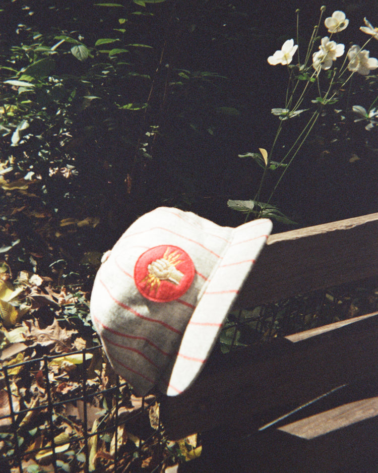 Ebbets Field Mystery Caps of Mexico – Electricistas De Necaxa 1935 Wool Ballcap in off-white wool with thin red pinstripes and a circular patch featuring a fist holding lightning bolts.