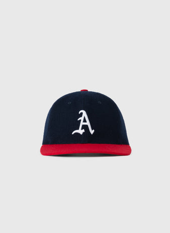 The EFF Atlanta Crackers 1956 Authentic Wool Ballcap features navy blue wool, a red brim, and a white embroidered A, displayed on a plain light gray background.