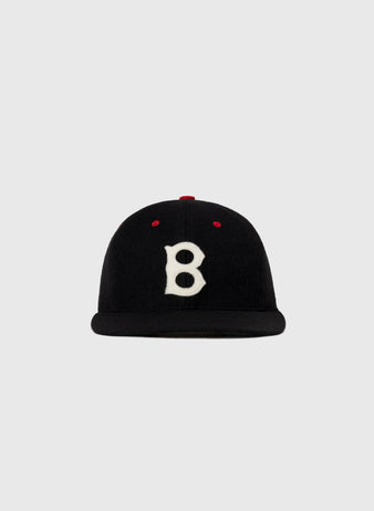 The EFF Baltimore Elite Giants 1947 Authentic Wool Ballcap is black with a white B front, red top stitching, and a flat brim, displayed on a plain gray background.