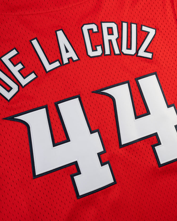 The Ebbets Field ELLY DE LA CRUZ BUTTON UP MESH JERSEY in red features DE LA CRUZ in white with black trim and large white 44 digits, also trimmed in black.