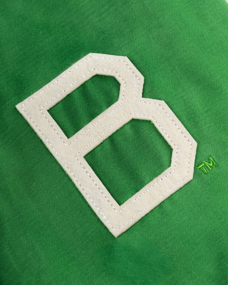 A large white stitched letter B stands out on the bright green fabric of the EFF Brooklyn Dodgers 1937 Satin Windbreaker Jacket, with a small matching TM symbol embroidered nearby.
