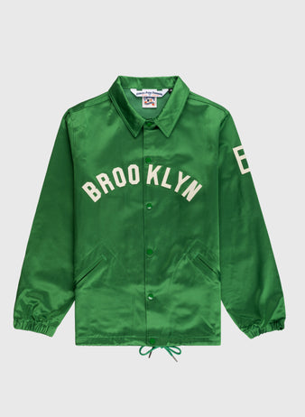The EFF Brooklyn Dodgers 1937 Satin Windbreaker Jacket features green satin, BROOKLYN in white across the chest, number 8 on the left sleeve, front pockets, a collar, and elastic cuffs. It is laid flat on a white background.