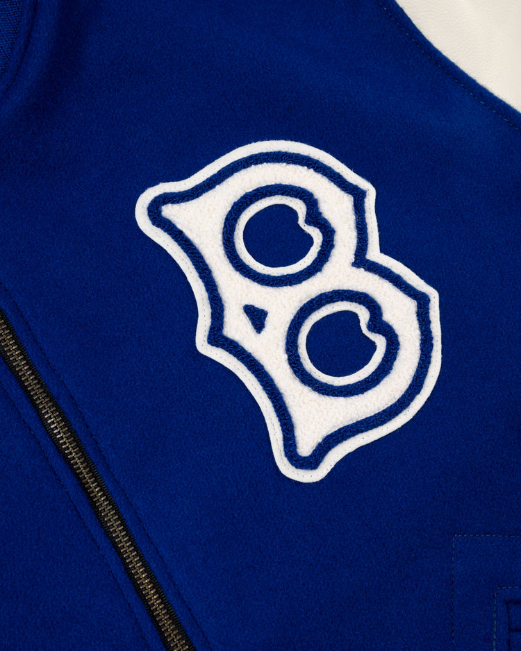 Close-up of a blue wool EFF Brooklyn Dodgers 1940 Authentic Varsity Jacket, showing a white and blue B patch and part of a black zipper.