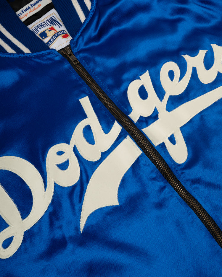 Close-up of the EFF Brooklyn Dodgers 1947-50 Authentic All Satin Varsity Jacket in blue, featuring white Dodgers script on the front, visible black zipper, and a partial view of the collar and inside label.
