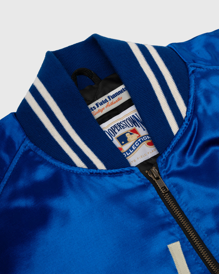 Close-up of the collar and zipper on an EFF Brooklyn Dodgers 1947-50 Authentic All Satin Varsity Jacket in shiny royal blue, with white-striped ribbed collar and Cooperstown Collection baseball-themed label inside.