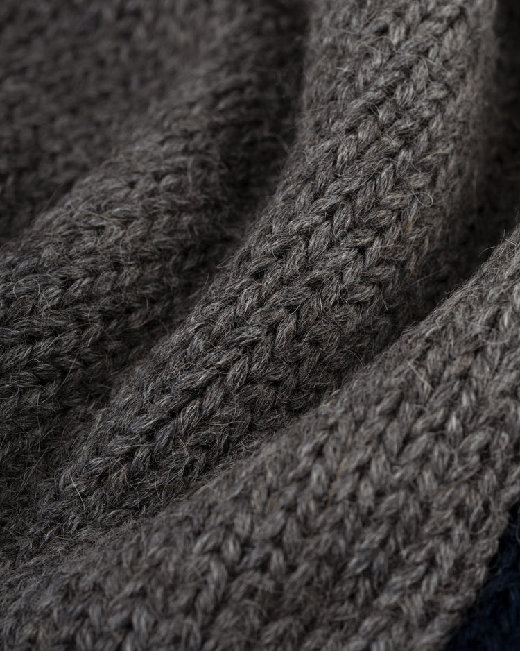 Close-up of a textured, brown knitted fabric with visible stitches and fibers, evoking the soft, cozy feel of the EFF Brooklyn Robins (Dodgers) 1916 Wool Shawl Collar Sweater.