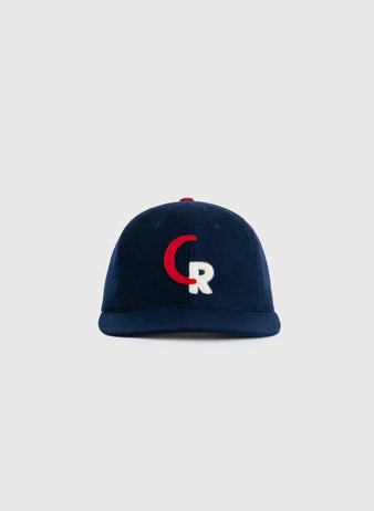 The EFF Caguas-Rio Piedras Criollos 1956-57 Authentic Wool Ballcap is navy blue, with a red and white CR logo on the front, shown against a plain light gray background.