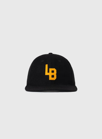 The EFF Cal State Long Beach 1961 Authentic Wool Ballcap is a black, flat-brim cap with yellow embroidered LB letters on the front, shown against a plain light gray background.