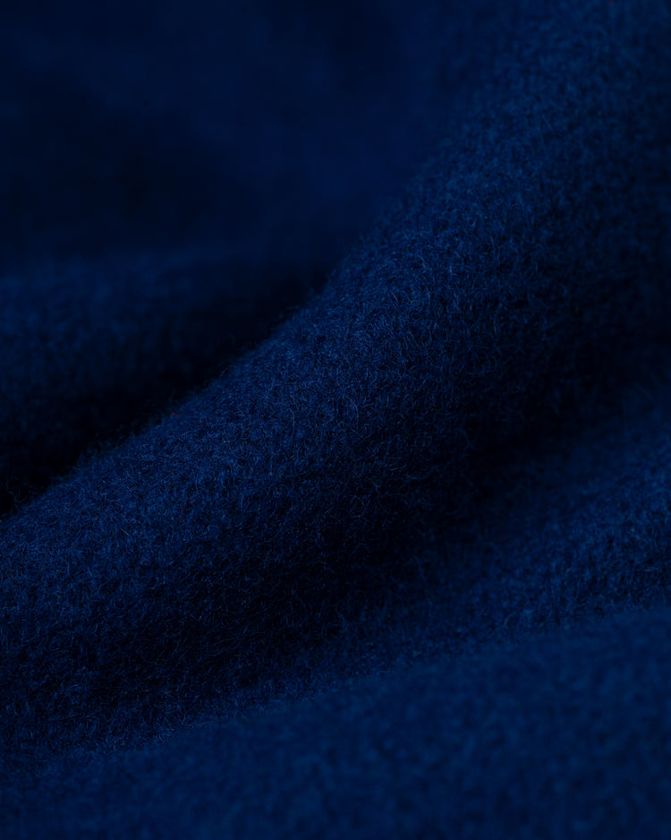 Close-up of textured, deep blue wool fabric with soft fibers and gentle folds from the EFF Chicago Cubs 1954 Authentic All Wool Varsity Jacket.