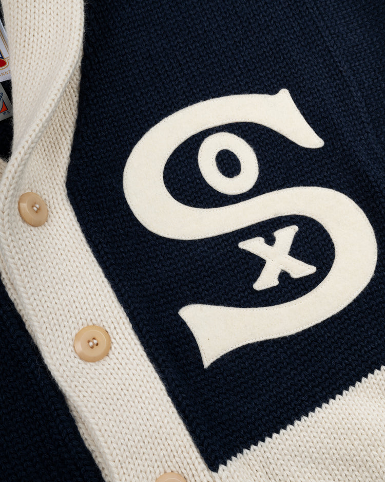 A close-up of the EFF Chicago White Sox 1926 Wool Shawl Collar Sweater in navy, with cream buttons and trim, and a large white “SOX” logo on the front—replicating the classic 1926 team style.
