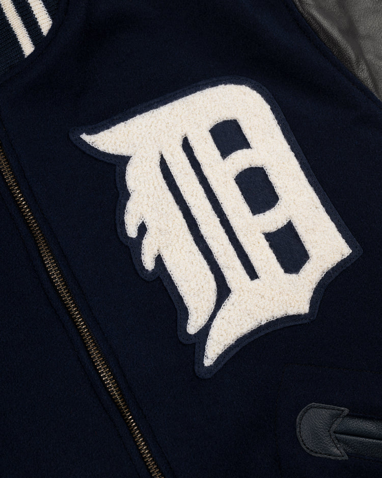 Close-up of the EFF Detroit Tigers 1955 Authentic Wool & Leather Varsity Jacket, featuring a large white textured D patch, visible zipper, and partial pocket detail—a replica of the classic Al Kaline style.