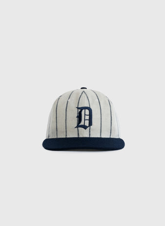 The EFF Duke University Pinstripe Authentic Wool Ballcap features vintage vertical pinstripes, a navy brim, and a bold navy D on the front, inspired by the 1968 Duke ballcap. Shown against a plain light gray background.